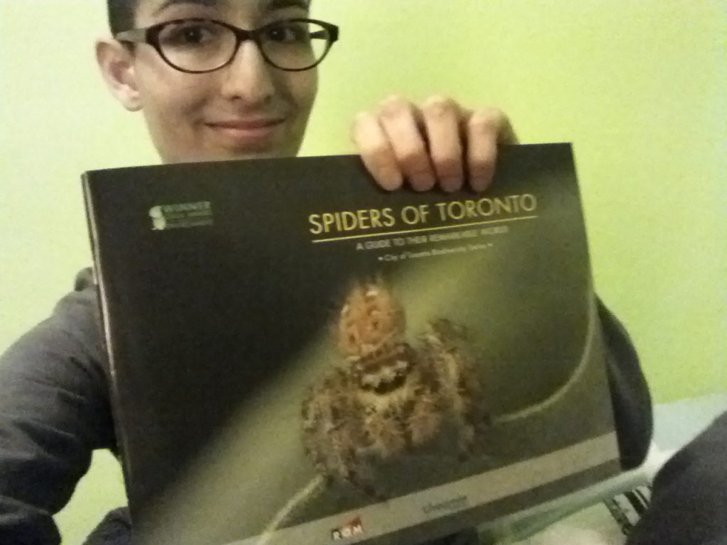 Me, holding up "Spiders of Toronto"