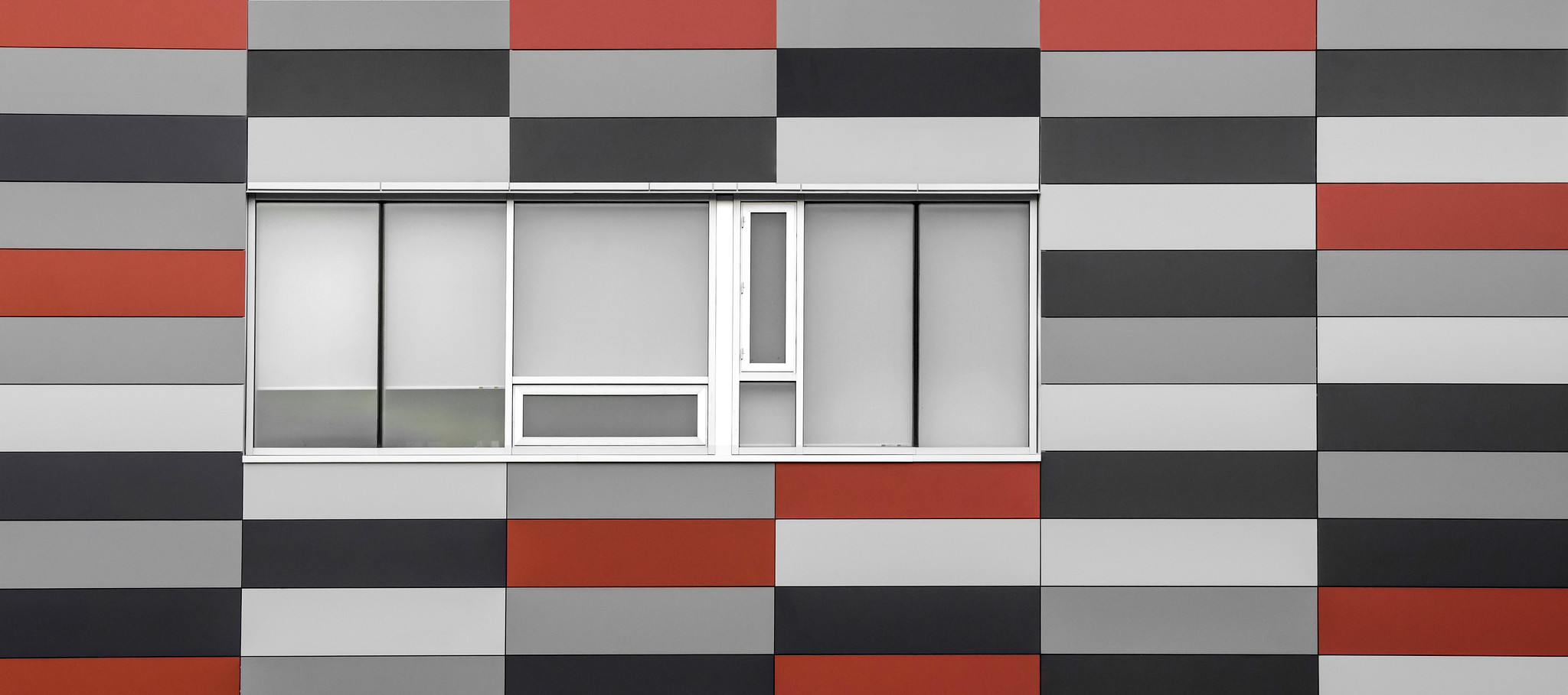 A red, grey, white, and black wall.
