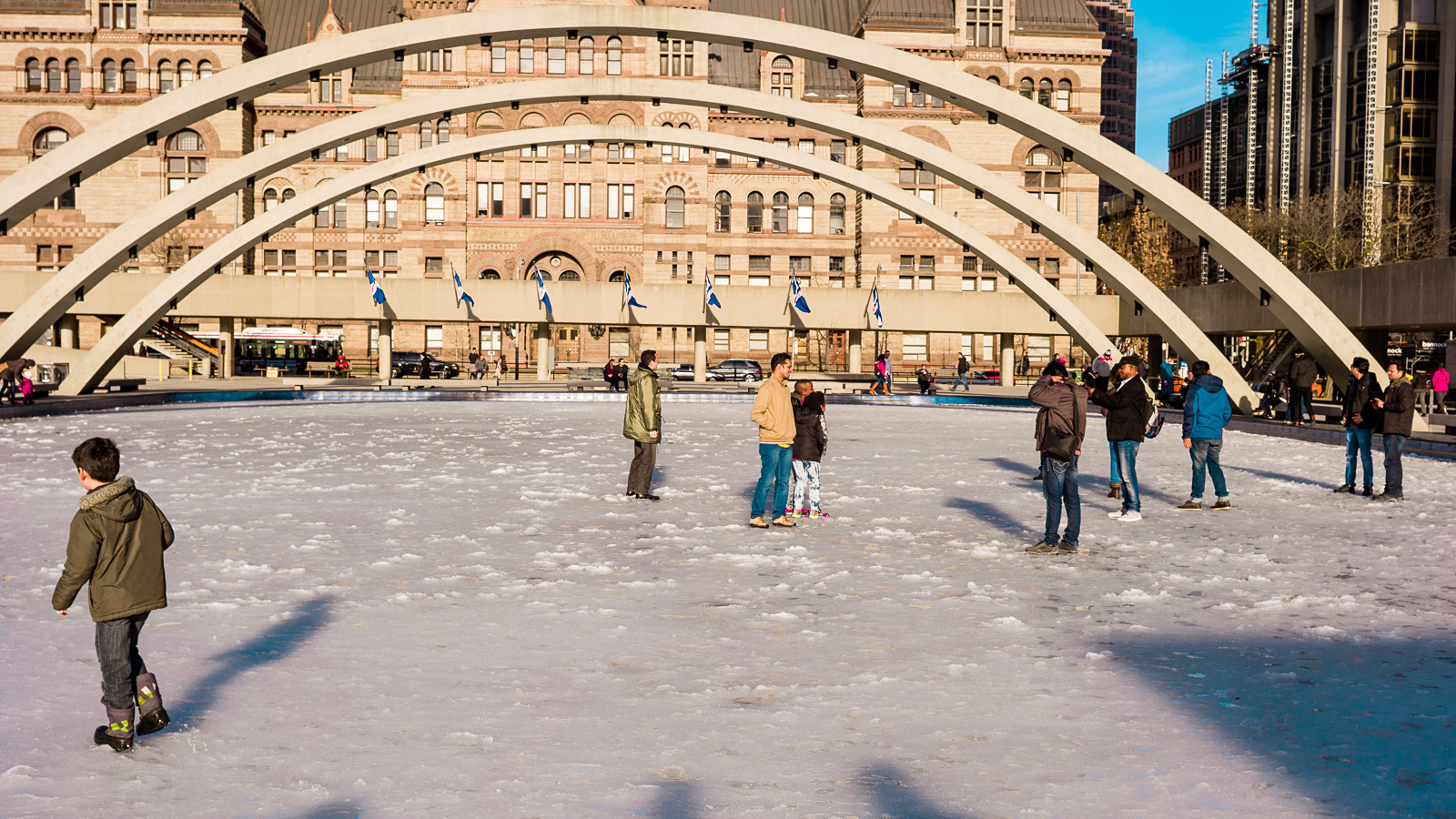 People playing in the slushy, frozen-over NPS reflecting pool.