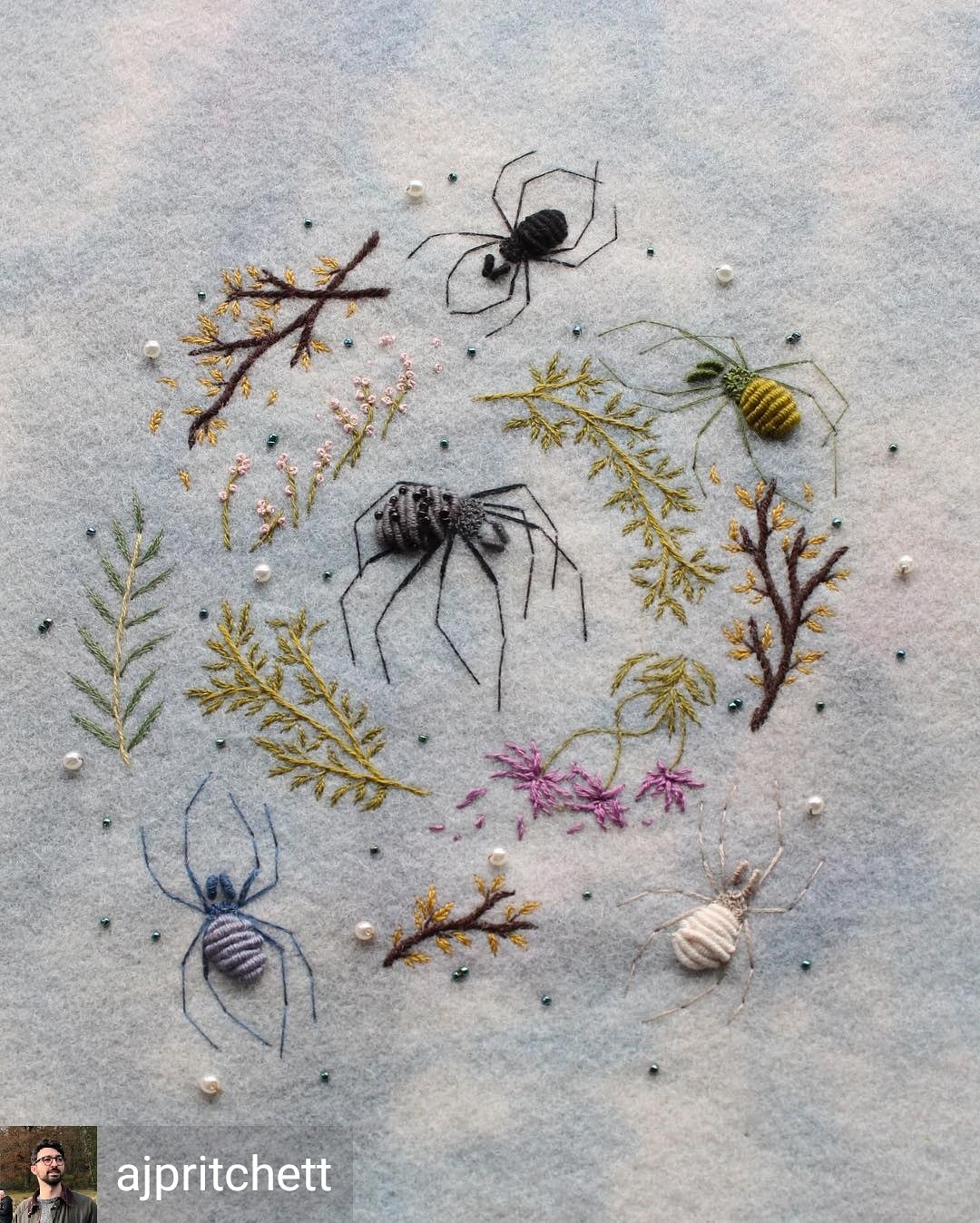 Embroidery of various spiders surrounded by plants