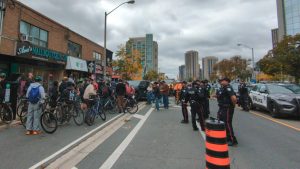 On Bloor St. just east of Islington, a motley crew of cyclists face off with police and construction workers (with a few reporters in the middle).