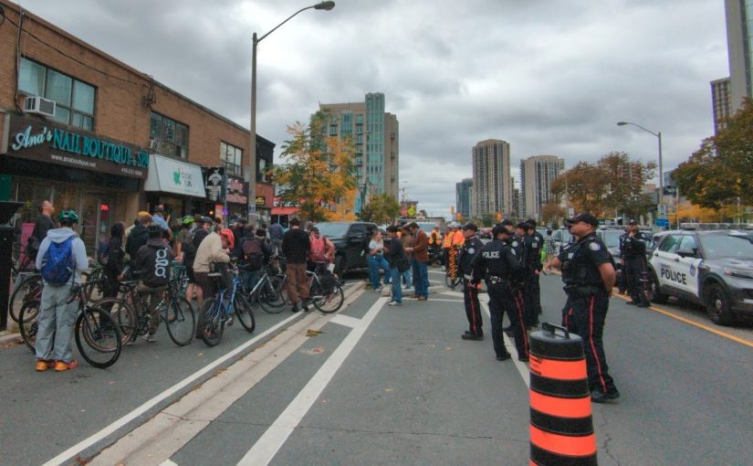 On Bloor St. just east of Islington, a motley crew of cyclists face off with police and construction workers (with a few reporters in the middle).