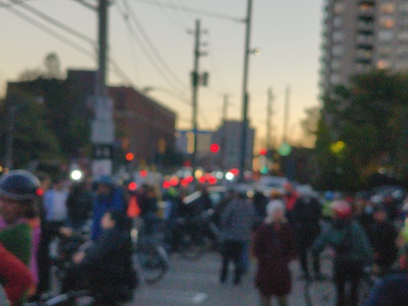 People protesting the removal of Bloor St. bike lanes gather at a parking lot in the evening of Oct. 20. Blurred for privacy.