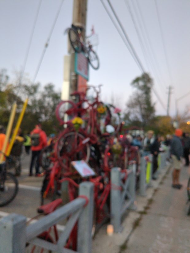 A monument made of a pile of red-painted bicycles, representing cyclist deaths and injuries on Toronto streets. Blurred for privacy.