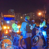 A protester in front of a big tractor-trailer stands in the way of police trying to get them to move.