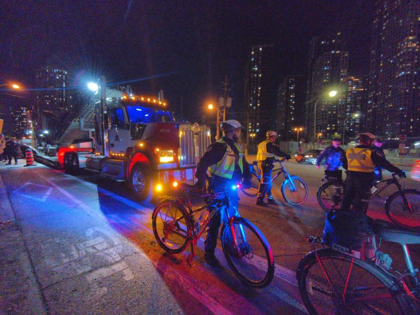 Bike police clear a way for one of the trucks hauling equipment to unload.