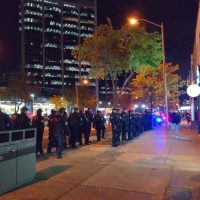 Riot police line up in two dense rows to prevent anyone getting to the bike lanes.